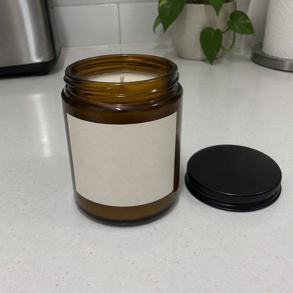 A plain phone photo of a candle jar on a kitchen counter